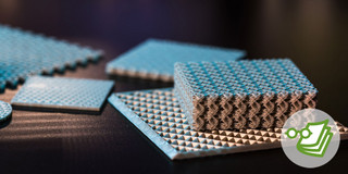 Ein Schwamm-ähnliches Kunststoffmaterial und mehrere Kunststoffplatten liegen auf einer schwarzen Oberfläche.
