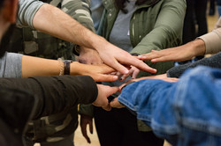 many different hands forming a circle