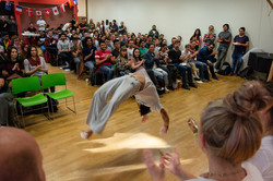 A big group of people watching a Capoeira performer in the IBZ
