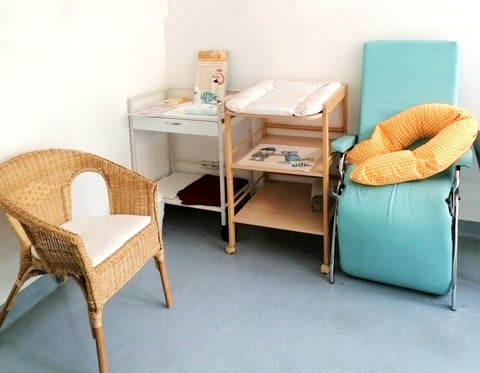 Kleine Sitzeecke mit einem Stillstuhl und einem Wickeltisch