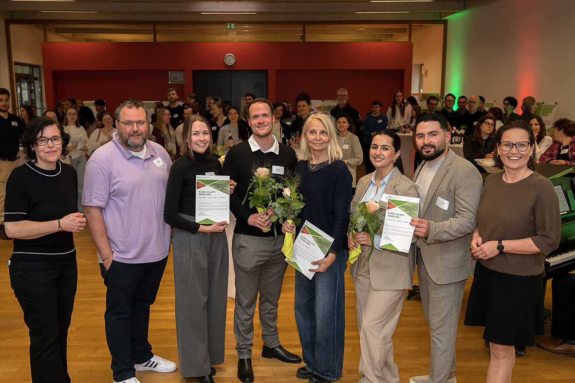 In the photo, eight people are smiling at the camera after the certificates were presented.