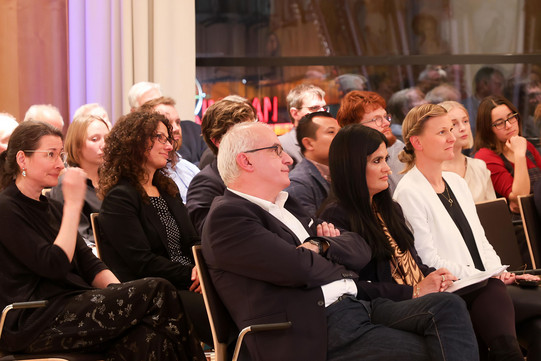 Seated audience of an event. The Rector of the TU Dortmund University (Prof. Manfred Bayer) is sitting in the front row.