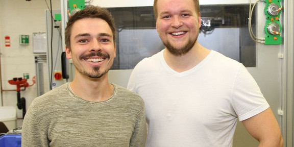 Two men standing in a workshop 