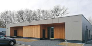 A building of the daycare center on the South Campus with trees in the background.