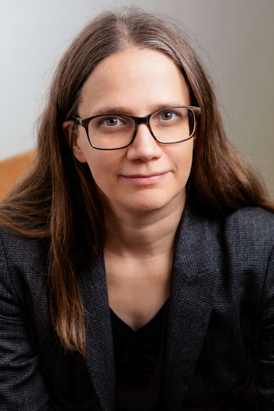 Portrait photo of Prof Eva Schmidt: The photo shows a woman with glasses and long dark hair.