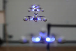 In the foreground two drones are flying, in the background more can be seen