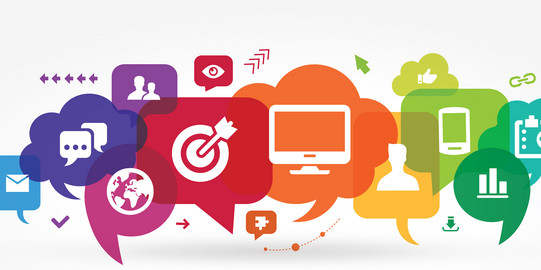 Colorful speech bubbles with icons including globe, target, computer, smartphone, and chart above the word 'COMMUNICATION' in rainbow colors.