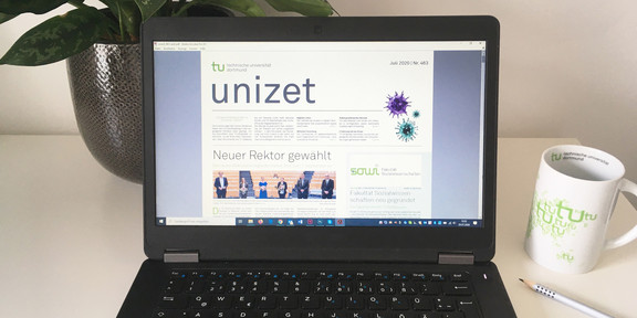 The current issue of unizet is open on a laptop