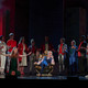 Several people stand on a stage