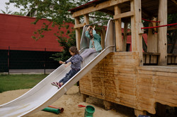Two children slide.