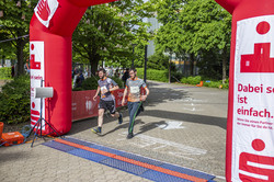 two runners run across the finish line
