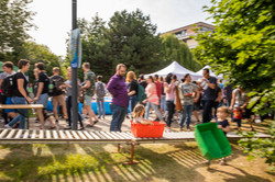 Kinder rutschen in Kisten über eine Rollbahn