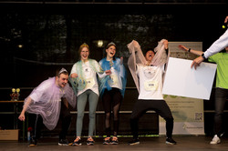Four people in princess costumes cheer on stage