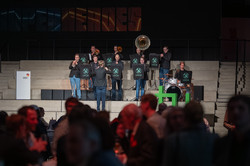 Photo: A band performs on stage in front of an audience.