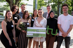 Group photo with TU logo and check 