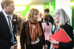 Two women and a man in conversation