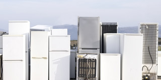 There are several white refrigerators next to each other.