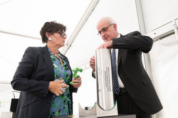 A man and a woman pack objects into a time capsule.