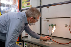 A man ignites a Bunsen burner