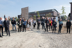 People standing on a construction site and all looking in one direction.