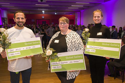 The three award winners hold a check in their hands