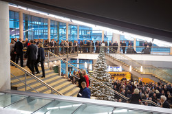 People stand in the foyer and in the gallery of the concert hall