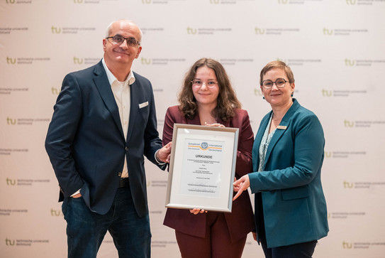 Soroptimist award winner Judith Bose You can see Soroptimist award winner Judith Bose with her certificate in her hand with the rector on the left and the president of the Soroptimist International Club Dortmund Daniela Fischer on the right.