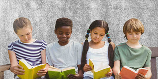 Four children sitting next to each other, each reading a book