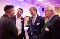 Four men talk to each other