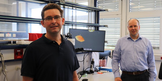 Two men standing in a laboratory