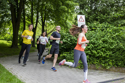 some runners jogging across the green campus