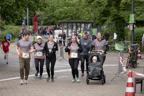 A group with stroller completes a running course.