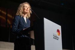 Photo: A person stands at a podium.