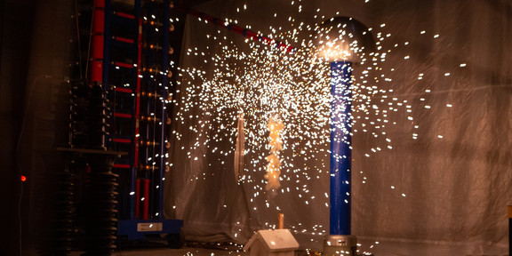 Small rockets in a dark room have just been lit and sparks can be seen.