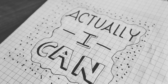On a squared sheet of paper, “Actually I can” is written and outlined with a line and dots.