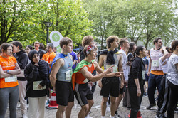 several people cheer on the runners