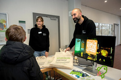 Das Bild zeigt Mitarbeitende des Centrums für Entrepreneurship & Transfer sowie einen Ecktisch. Auf diesem liegen unter anderem Flyer und Jutebeutel.