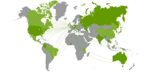 Graphic design of a green and gray world map without country names. Countries with cooperating universities are shown in green.
