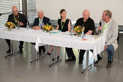 Panel discussion Five people sitting in a row at a table