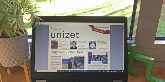 On a laptop screen you can see the current issue of unizet
