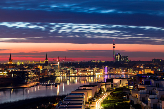 Atmospheric evening light at the Phoenix lake, in the background the skyline of Dortmund