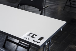Klausur in den Westfalenhallen Ein weißer Tisch, auf dem ein Zettel mit der Aufschrift "Block E, Platz 37" liegt.