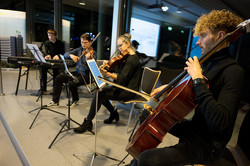 The music ensemble plays on stage.