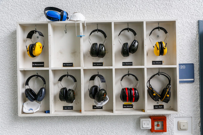 A shelf with hearing protection ear muffs
