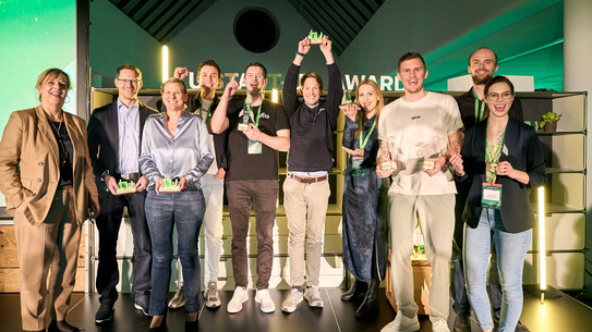 Jubelnde Menschen mit Preisen in der Hand.