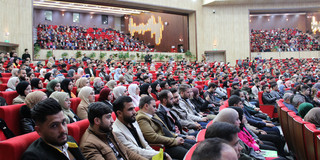 A hall full of people at the student conference