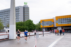 Foto: Zwei Läuferinnen laufen auf einer abgesperrten Strecke über den Campus.