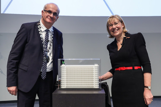 Professor Ursula Gather and Professor Manfred Bayer innext to a model of the math building of TU Dortmund University.