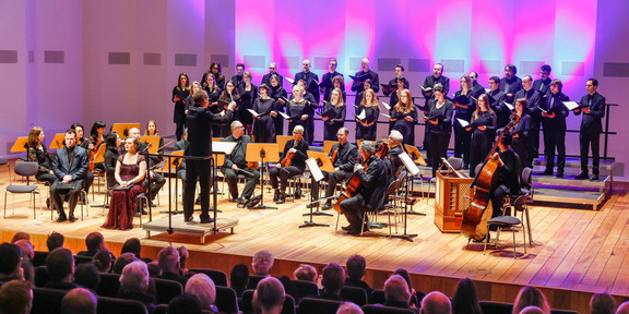 Chamber choir, philharmonic orchestra and conductor on stage