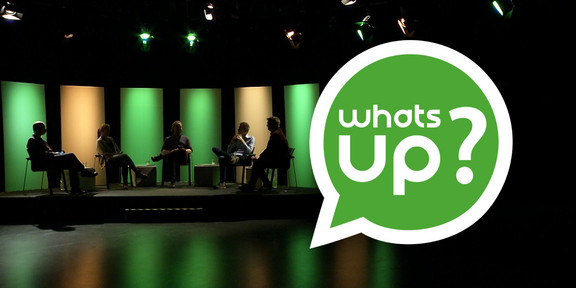 The "WhatsUp" logo with a panel discussion in the background.